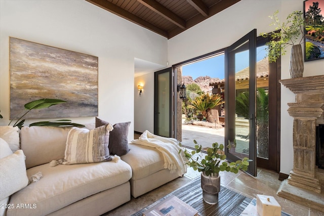 living area featuring beam ceiling and wood ceiling