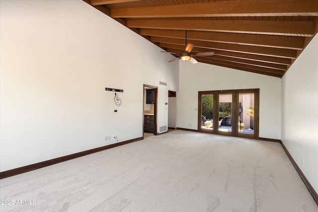 spare room featuring beamed ceiling, baseboards, light colored carpet, and french doors