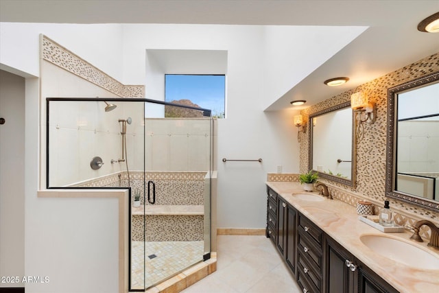 full bath with a sink, a healthy amount of sunlight, and a shower stall