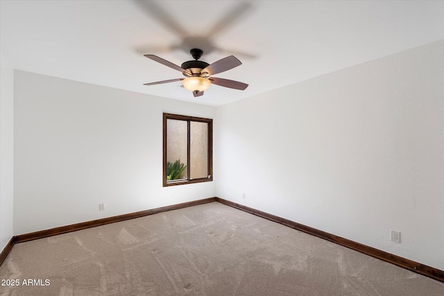 empty room featuring ceiling fan, baseboards, and carpet floors