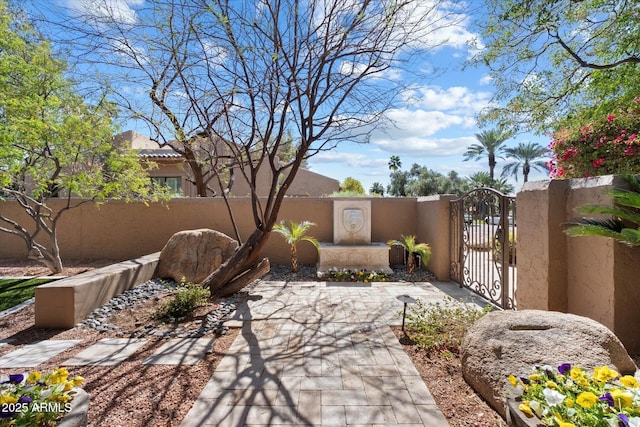 view of patio with a gate and fence