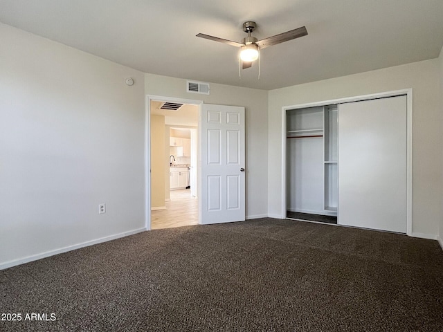 unfurnished bedroom featuring ceiling fan, a closet, and carpet