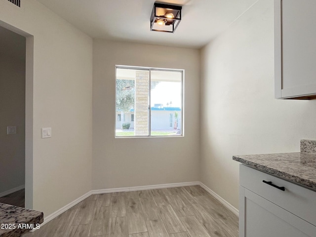 unfurnished dining area with light hardwood / wood-style floors