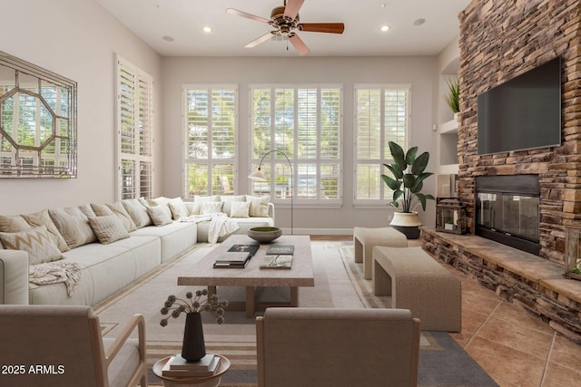 3654 E San Pedro Pl, Chandler, AZ 85249 - living room featuring a ceiling fan, a stone fireplace, recessed lighting, and tile patterned flooring