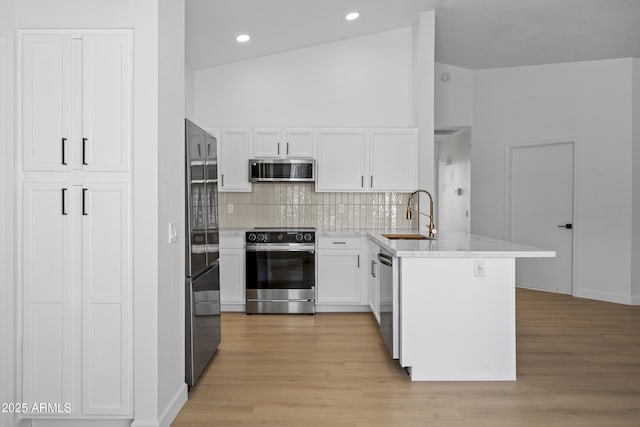 1881 E Kerby Farms Rd, Chandler, AZ 85249 - kitchen with appliances with stainless steel finishes, a peninsula, decorative backsplash, white cabinets, and recessed lighting