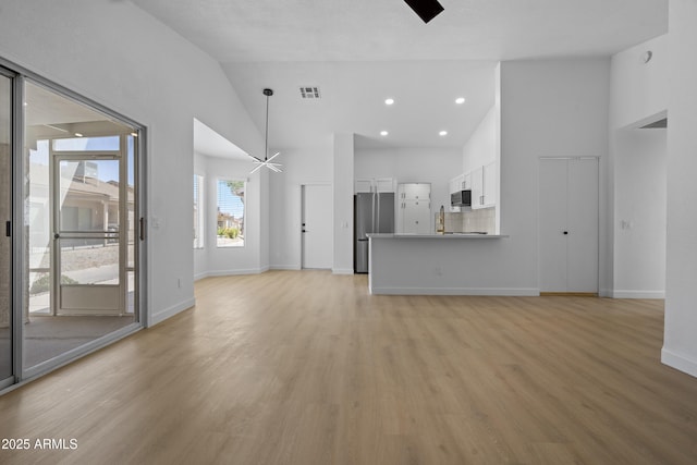 1881 E Kerby Farms Rd, Chandler, AZ 85249 - unfurnished living room featuring ceiling fan, high vaulted ceiling, light wood finished floors, and recessed lighting