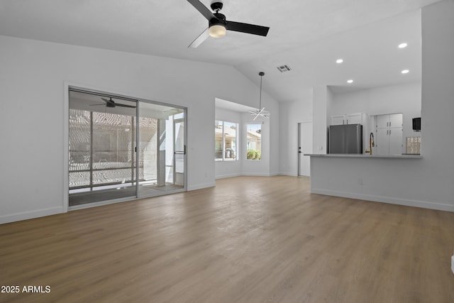 1881 E Kerby Farms Rd, Chandler, AZ 85249 - unfurnished living room featuring ceiling fan, light wood finished floors, recessed lighting, and high vaulted ceiling