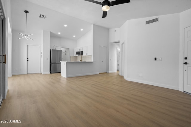 1881 E Kerby Farms Rd, Chandler, AZ 85249 - unfurnished living room with ceiling fan, high vaulted ceiling, light wood-style flooring, and recessed lighting