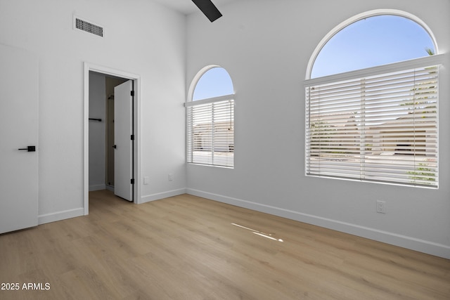 1881 E Kerby Farms Rd, Chandler, AZ 85249 - unfurnished bedroom with wood finished floors, a high ceiling, and a spacious closet