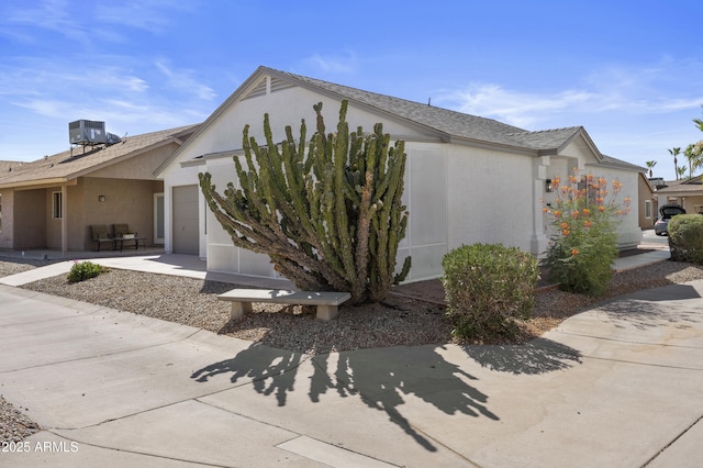 1881 E Kerby Farms Rd, Chandler, AZ 85249 - view of side of property featuring an attached garage and stucco siding