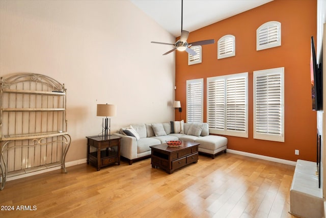 living room with light hardwood / wood-style flooring, high vaulted ceiling, and ceiling fan