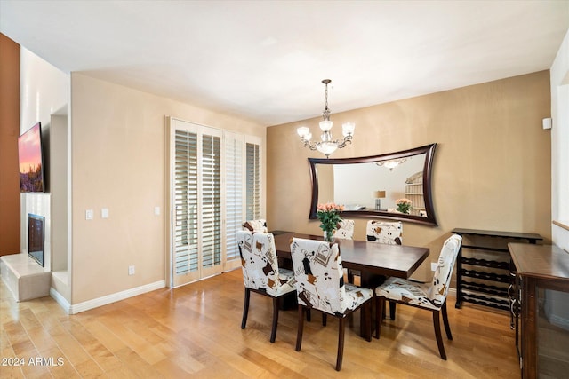 dining room featuring an inviting chandelier and light hardwood / wood-style flooring