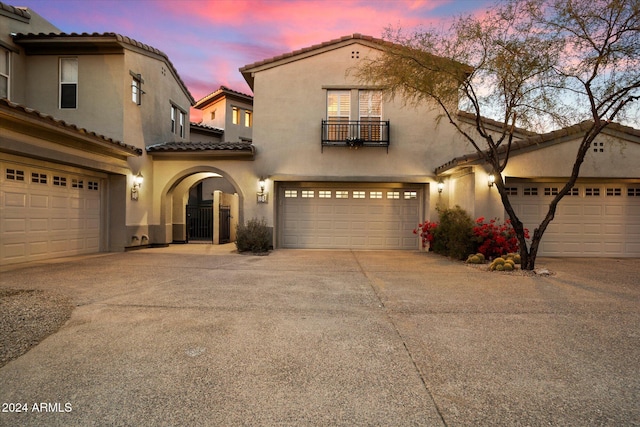 mediterranean / spanish home featuring a garage