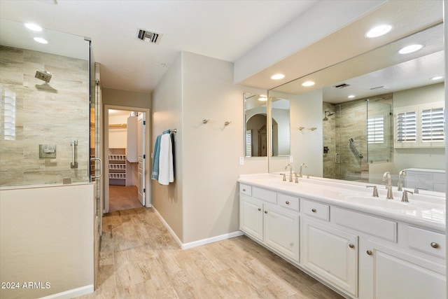 bathroom featuring vanity, hardwood / wood-style floors, and an enclosed shower