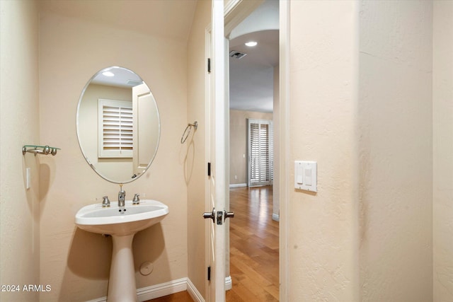 bathroom with sink and wood-type flooring