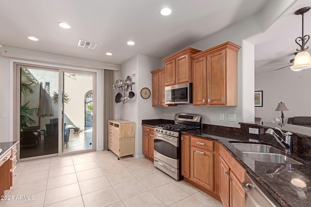 kitchen featuring recessed lighting, visible vents, appliances with stainless steel finishes, a sink, and dark stone counters