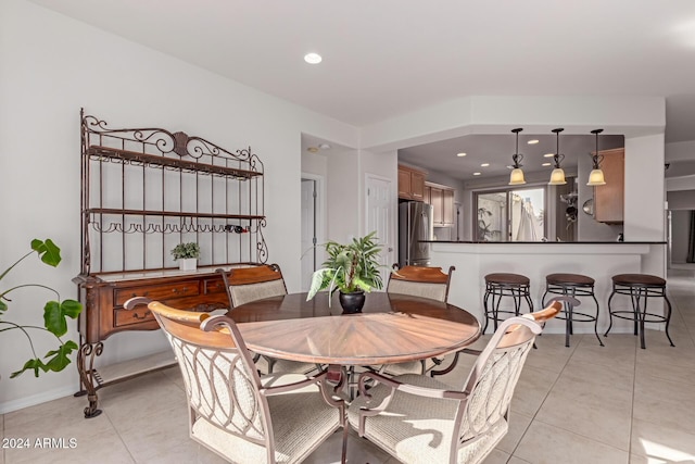 dining area with light tile patterned flooring and recessed lighting