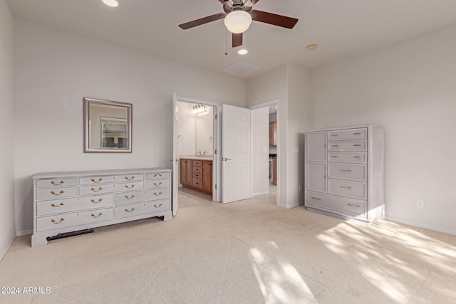 unfurnished bedroom with a ceiling fan, light colored carpet, connected bathroom, and baseboards