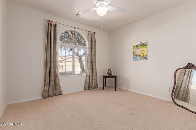 empty room featuring a ceiling fan, baseboards, visible vents, and carpet flooring