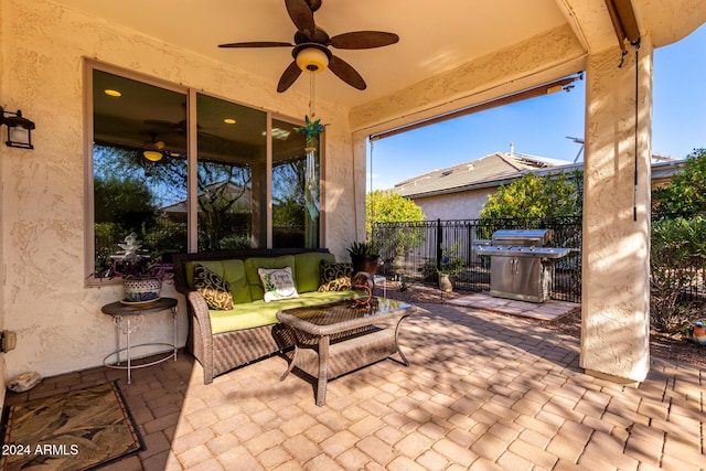 view of patio with fence, grilling area, a ceiling fan, and an outdoor living space