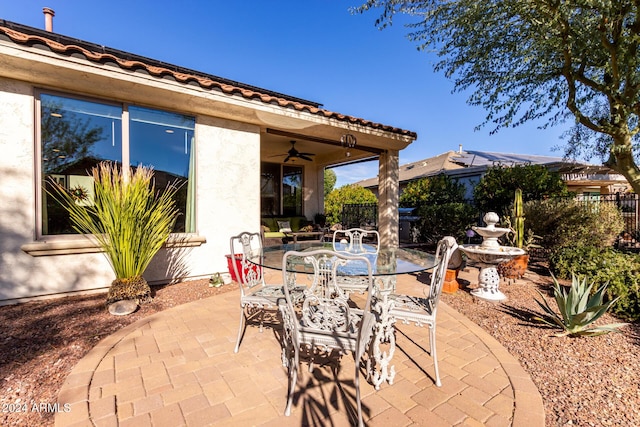 view of patio / terrace with a ceiling fan and fence