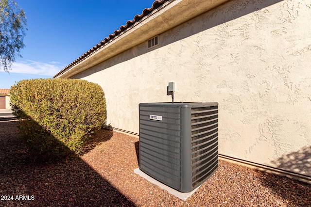 details featuring cooling unit and stucco siding