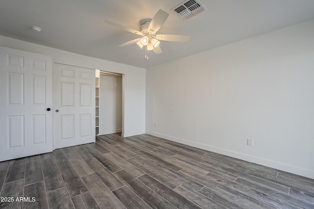 unfurnished bedroom featuring dark hardwood / wood-style flooring, a closet, and ceiling fan