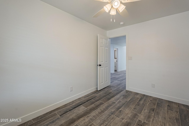 empty room with ceiling fan and dark hardwood / wood-style floors