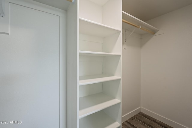 walk in closet featuring dark hardwood / wood-style floors