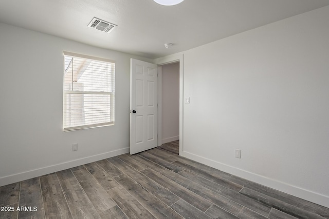 empty room with dark hardwood / wood-style floors