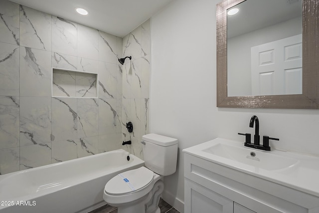 full bathroom featuring vanity, tiled shower / bath combo, and toilet