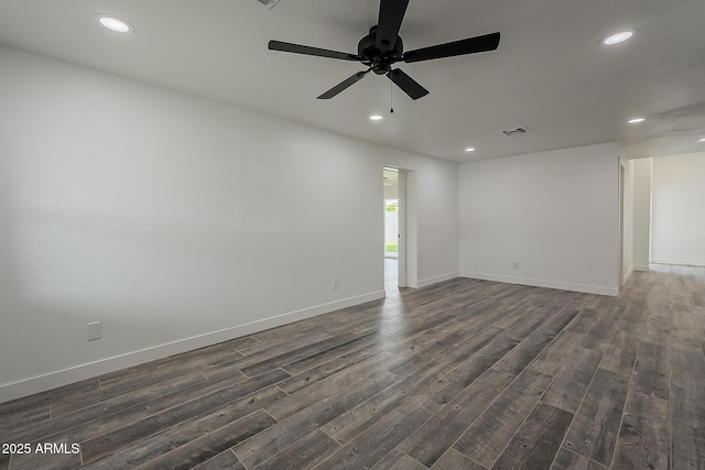 spare room with ceiling fan and dark hardwood / wood-style flooring