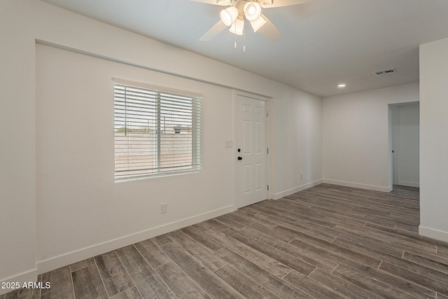 spare room with ceiling fan and dark hardwood / wood-style floors