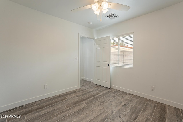 unfurnished room with ceiling fan and dark hardwood / wood-style flooring