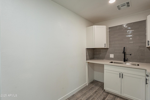 laundry area with sink and dark wood-type flooring