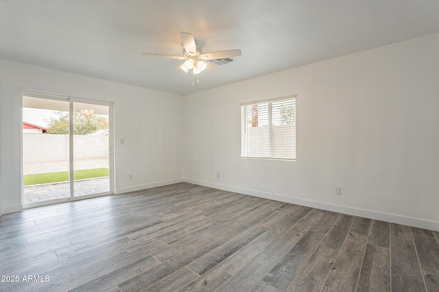 spare room with ceiling fan and dark hardwood / wood-style flooring