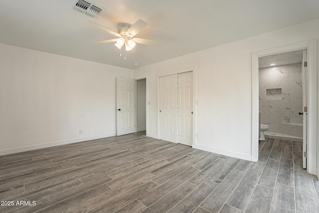 unfurnished bedroom featuring ensuite bath, a closet, and ceiling fan