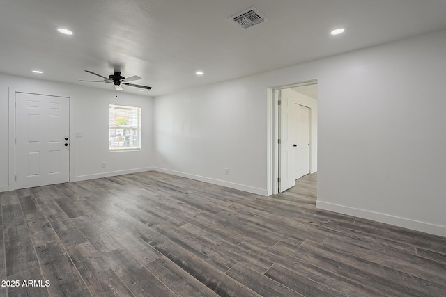 spare room with ceiling fan and dark hardwood / wood-style floors