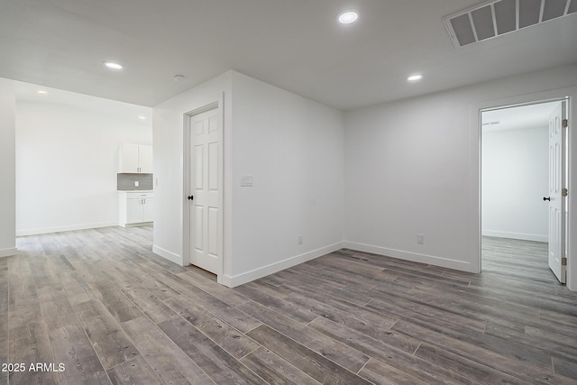 unfurnished room with hardwood / wood-style floors