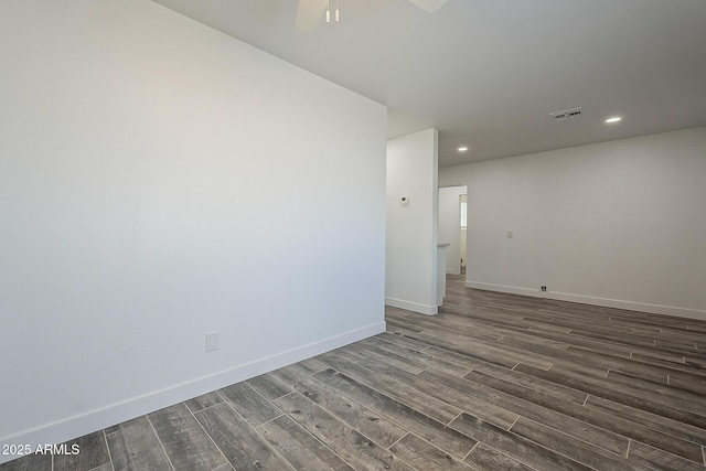 unfurnished room with ceiling fan and dark hardwood / wood-style floors