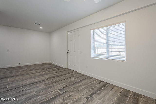 unfurnished room featuring ceiling fan and dark hardwood / wood-style floors