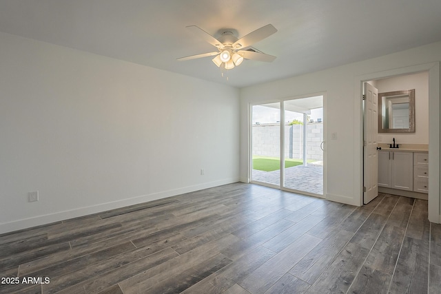 unfurnished room featuring ceiling fan, dark hardwood / wood-style flooring, and sink