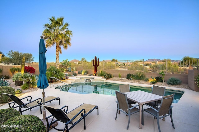 view of pool with a patio and an in ground hot tub