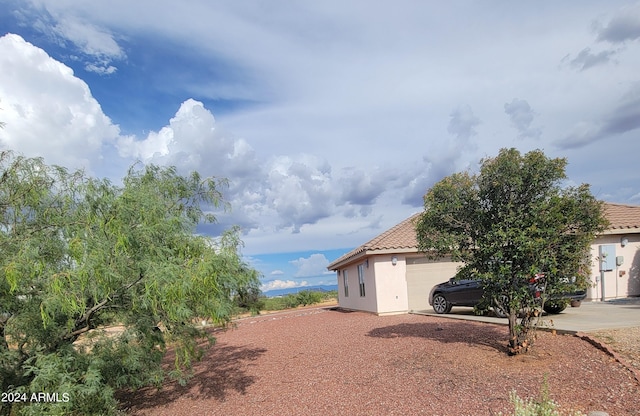 view of side of property with a garage