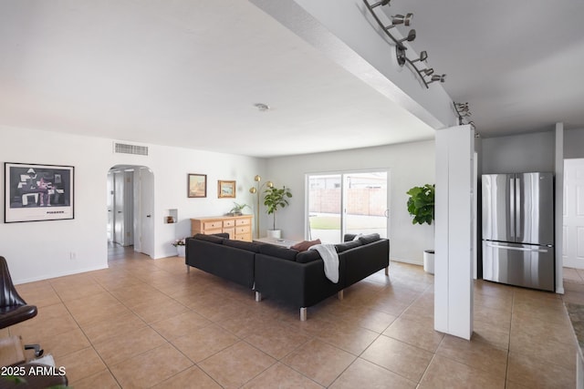 1330 E Monte Vista Rd, Phoenix, AZ 85006 - living room with arched walkways, light tile patterned floors, and baseboards