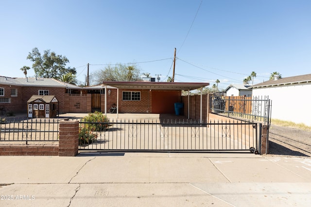1330 E Monte Vista Rd, Phoenix, AZ 85006 - ranch-style house featuring a fenced front yard, a gate, an attached carport, driveway, and brick siding