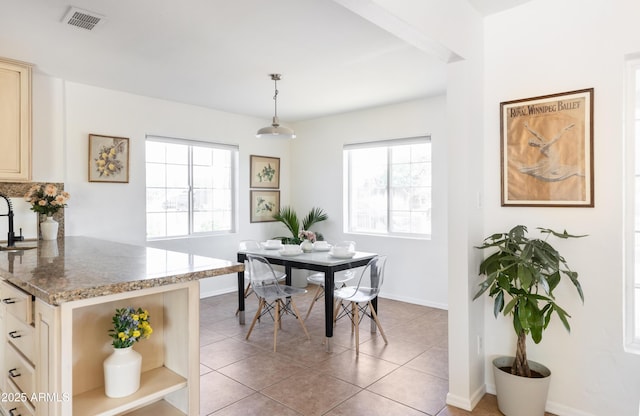 1330 E Monte Vista Rd, Phoenix, AZ 85006 - dining space featuring healthy amount of natural light, baseboards, and light tile patterned floors