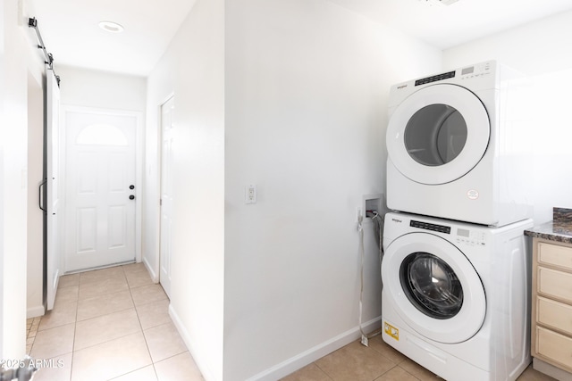 1330 E Monte Vista Rd, Phoenix, AZ 85006 - clothes washing area featuring estacked washer and dryer, light tile patterned flooring, and baseboards