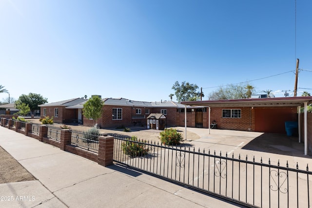1330 E Monte Vista Rd, Phoenix, AZ 85006 - ranch-style house featuring a carport, brick siding, a fenced front yard, concrete driveway, and a residential view