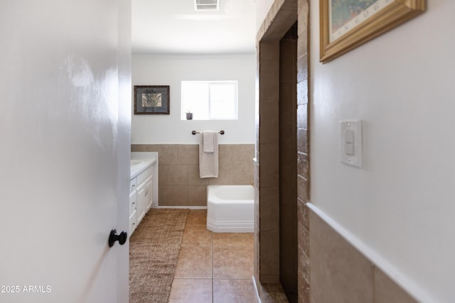 1330 E Monte Vista Rd, Phoenix, AZ 85006 - bathroom featuring tile patterned floors, tile walls, vanity, a bath, and crown molding